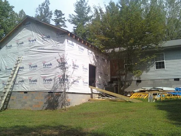 Tyvek wrapped gable on a new room addition beside an existing home in Walworth
